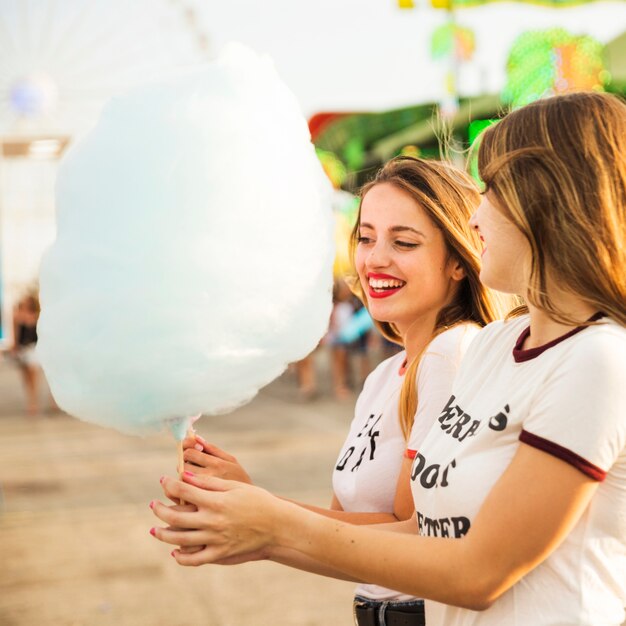 Two happy female friends with candy floss