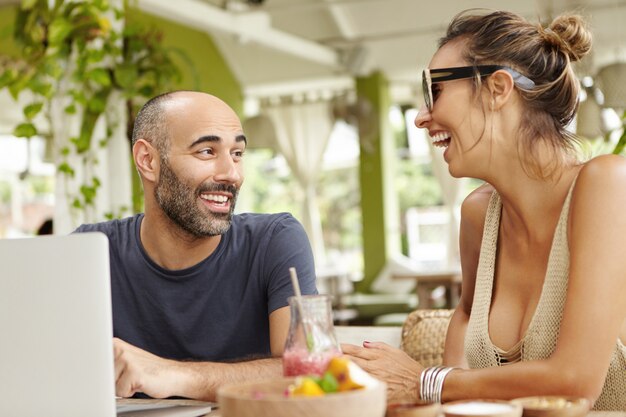 Two happy friends chatting and laughing, haven't seen each other for long time.