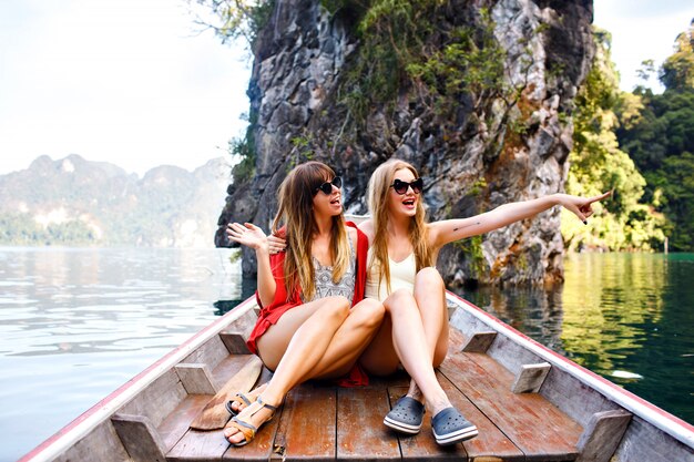 Two happy friends spending vacation in Thailand Khao Sok mountains and lake
