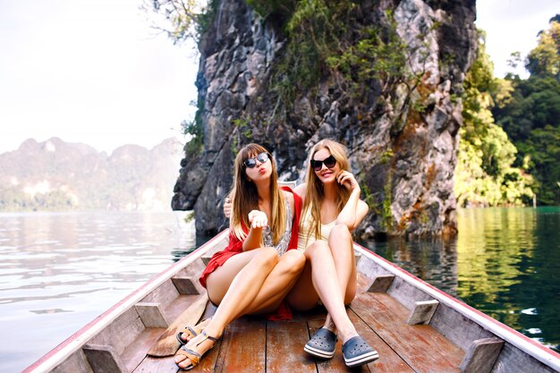 Two happy friends spending vacation in Thailand Khao Sok mountains and lake