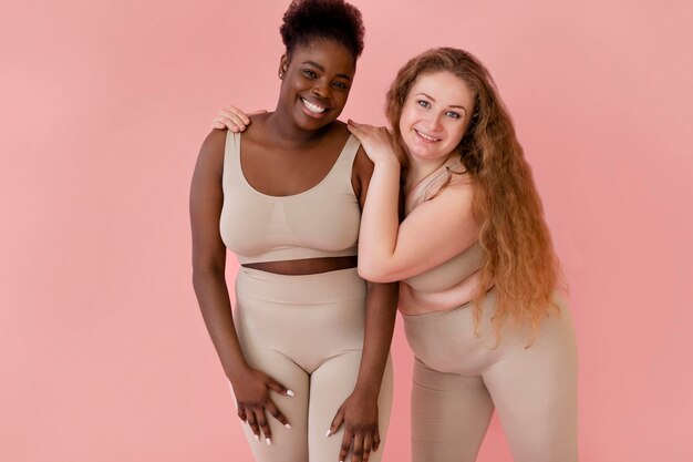 Two happy women posing while wearing a body shaper