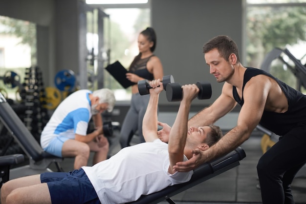 Two hardworking men training with weights