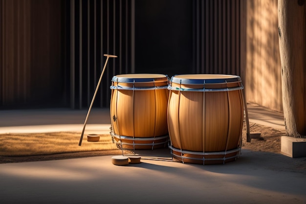 Free photo two japanese drums sit on a patio with a stick in the foreground.