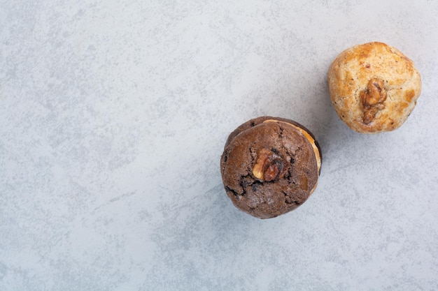 Two kind of cookies with walnut on gray background. High quality photo