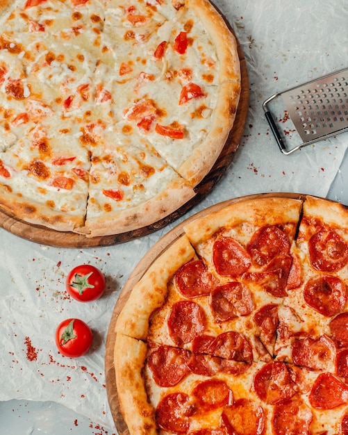 Two kind of pizza on the table