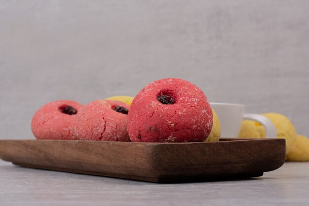 Two kinds of cookies on wooden plate.