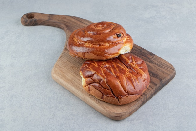 Two kinds of pastries on wooden board. 