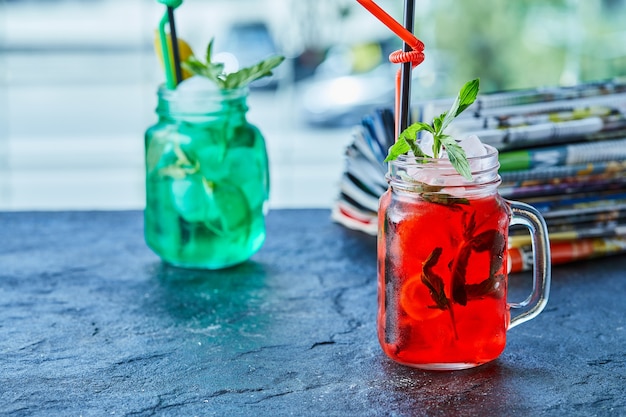 Two lemonades with mint and lemon on the marble surface 