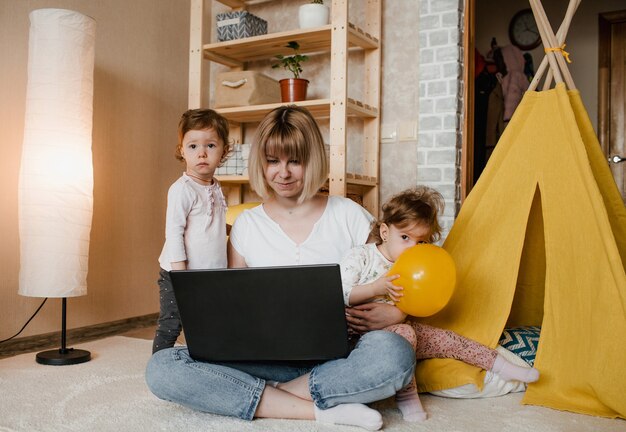 双子の男の子と女の子が緑の木で屋外で一緒にポーズを笑って幸せな家族 プレミアム写真