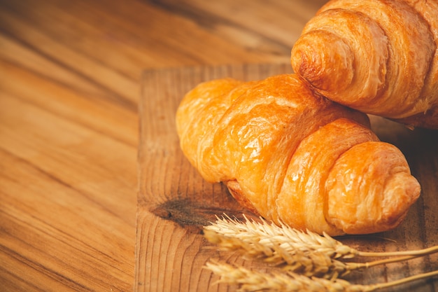 Two loaves of bread and barley Laid on the old wooden floor.