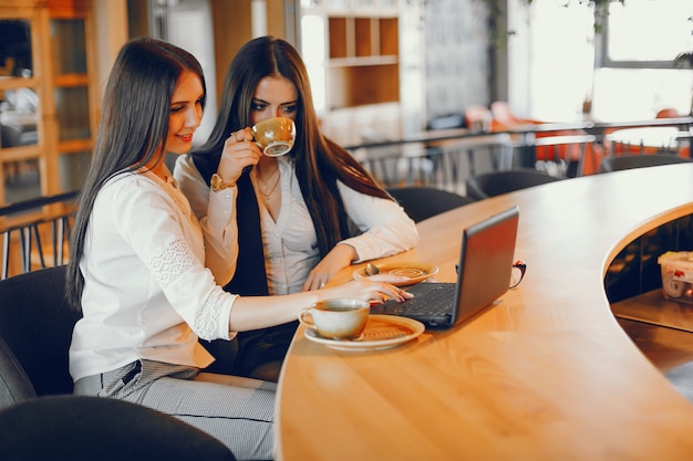 two luxury girl sitting in a restaurant