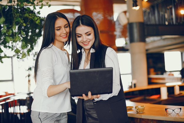 two luxury girl standing in a restaurant