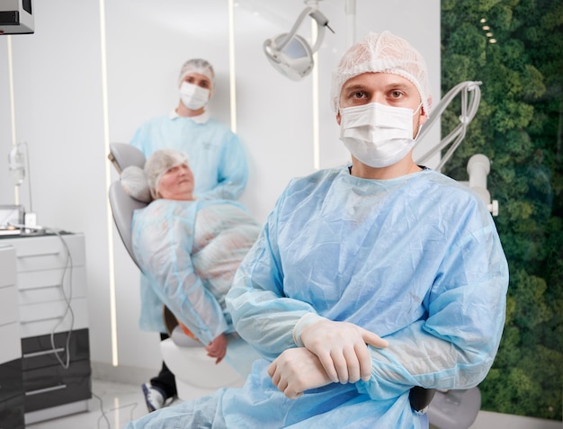 Free photo two male dentists and female patient in dental office