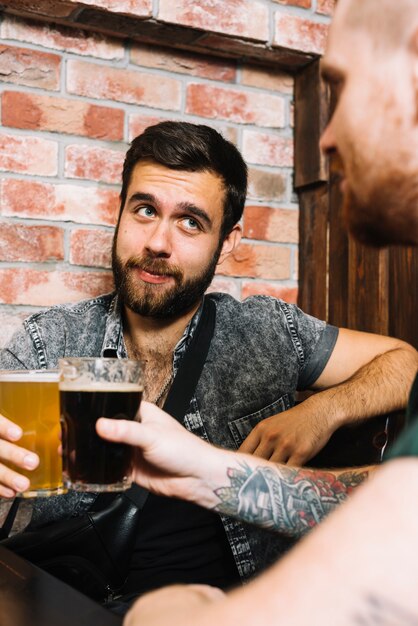 Two male friends toasting alcoholic drinks