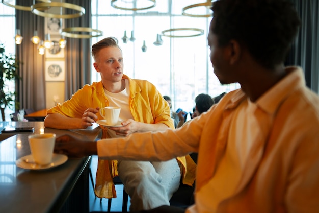 Two male friends together at restaurant