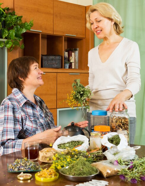 Two mature women with  herbs