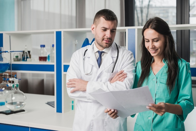 Two medics reading paper