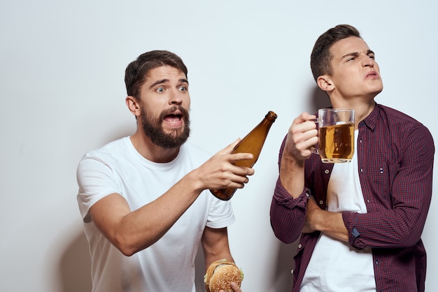 Premium Photo Two Men Have Fun Drink Beer And Eat Fast Food