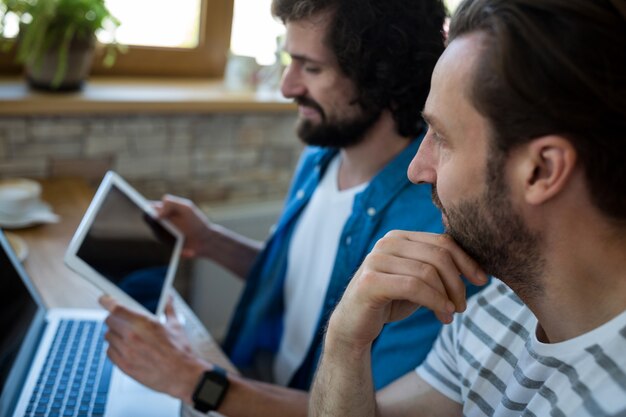 Two men looking at digital tablet