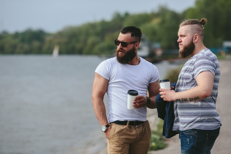 Free Photo two men stand and drink coffee