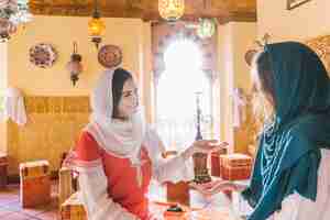 Free photo two muslim women in restaurant