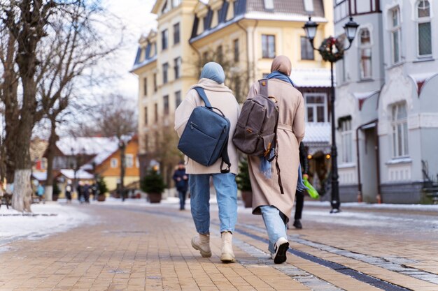 Two muslim women walking around the city while traveling