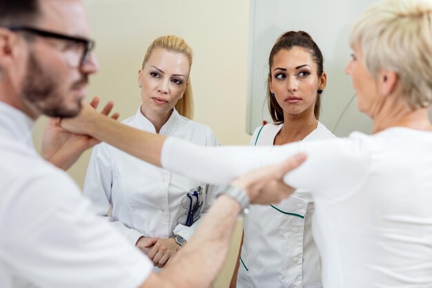 Two nurses attending examination of a patient before MRI scan procedure in the hospital