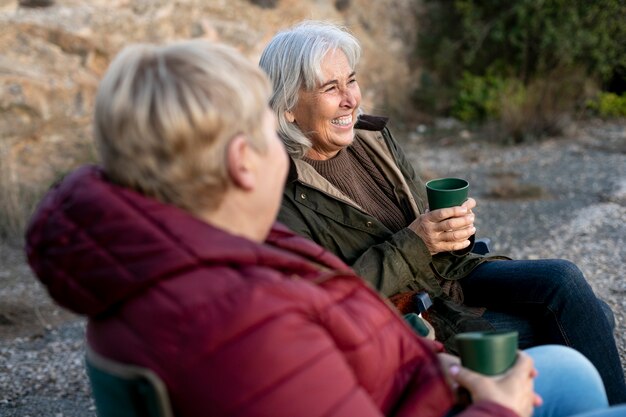 Two older female friends enjoying a hike together in nature