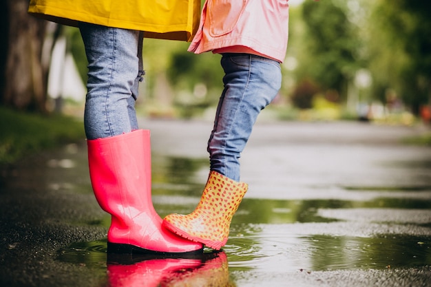 Two pair of rubber boots close up in the street