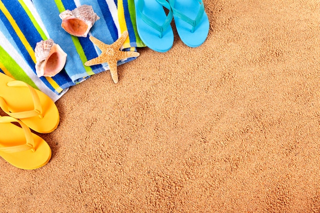 Two pairs of flip flops on the beach