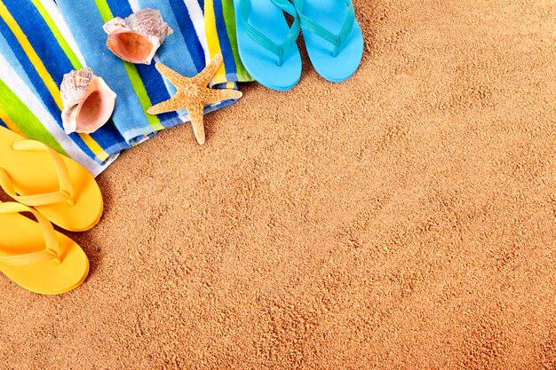 Two pairs of flip flops on the beach