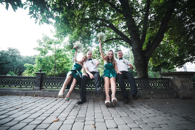 Two pairs of wedding guests posing