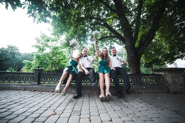 Two pairs of wedding guests posing