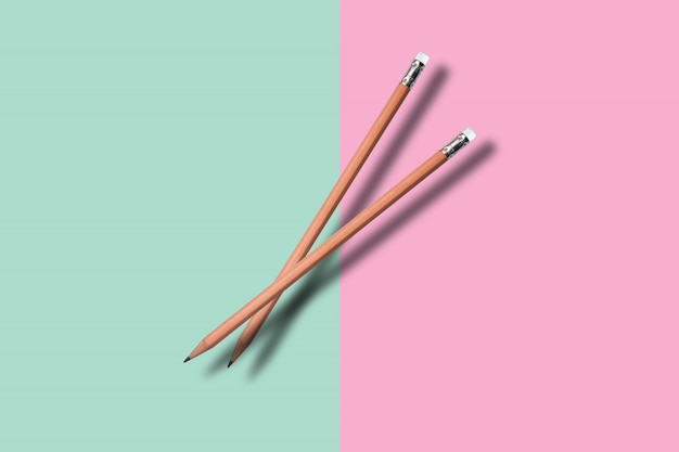 Two a pencil on colore background