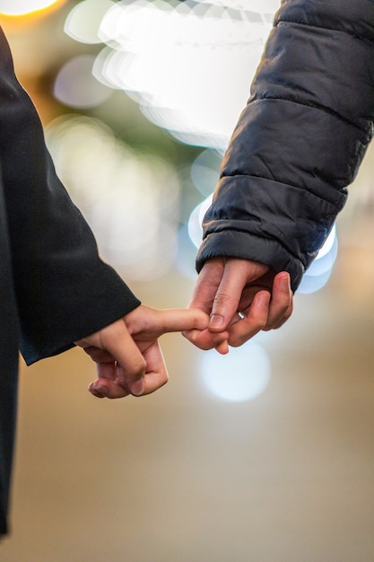 Two people holding each others hands