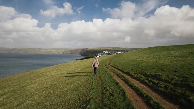 Two people walking along a road surrounded with amazing nature