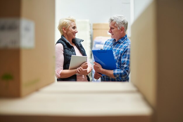 Two people working in warehouse