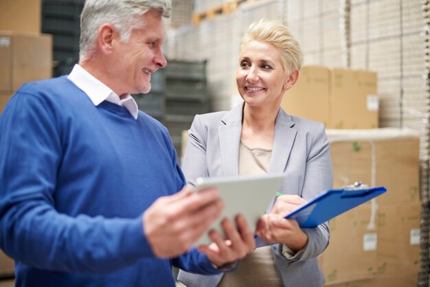 Two people working in warehouse