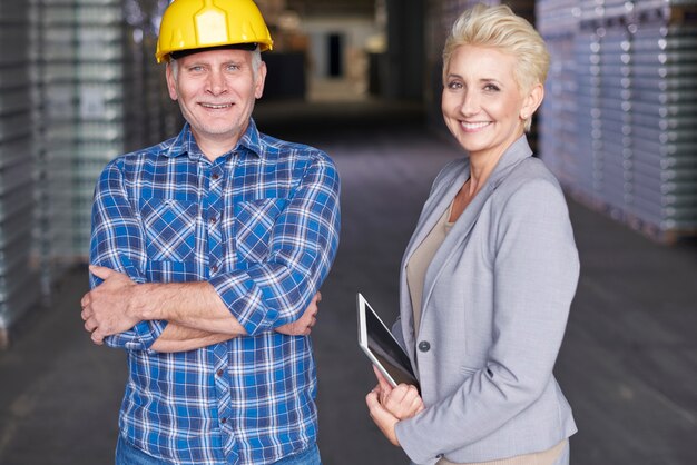 Two people working in warehouse