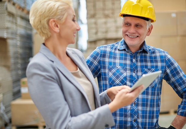 Two people working in warehouse