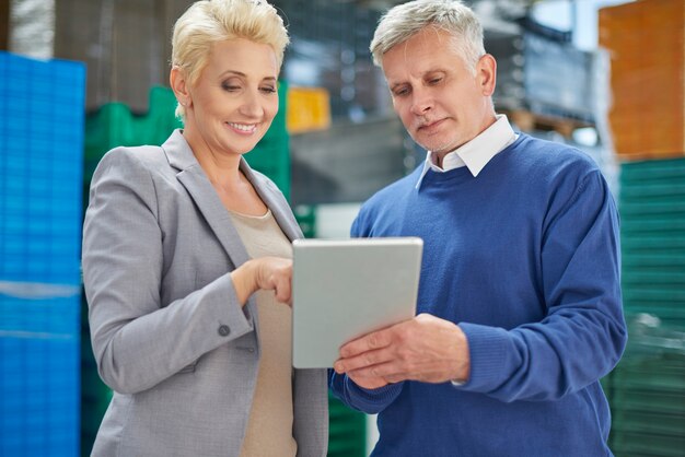 Two people working in warehouse