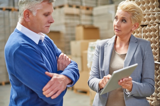 Two people working in warehouse