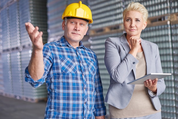 Two people working in warehouse