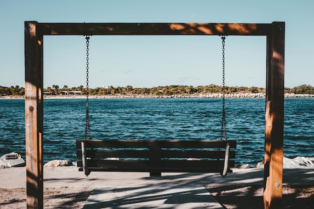 A two-person swing at the coast of a river