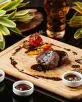 Free photo two pieces of round small steaks with pomegranate sauce and grilled vegetables