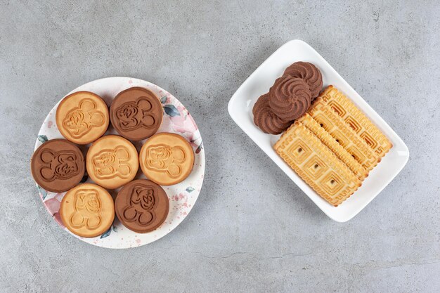 Two plates of homemade cookies on marble background. High quality photo