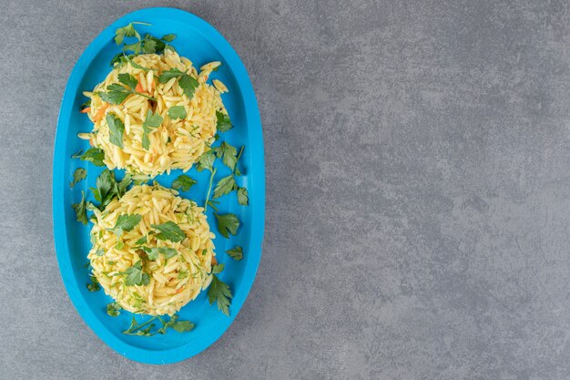 Two portions of delicious rice on blue plate. High quality photo