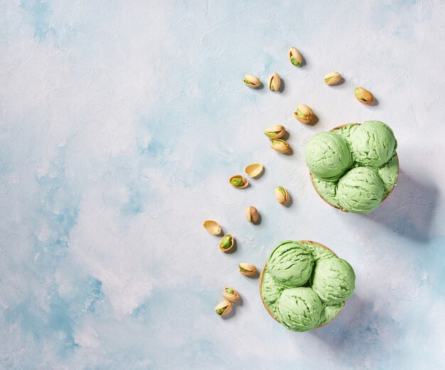 Download Premium Photo Pistachio Ice Cream In Paper Cup On Mint Colors Background Selective Focus PSD Mockup Templates