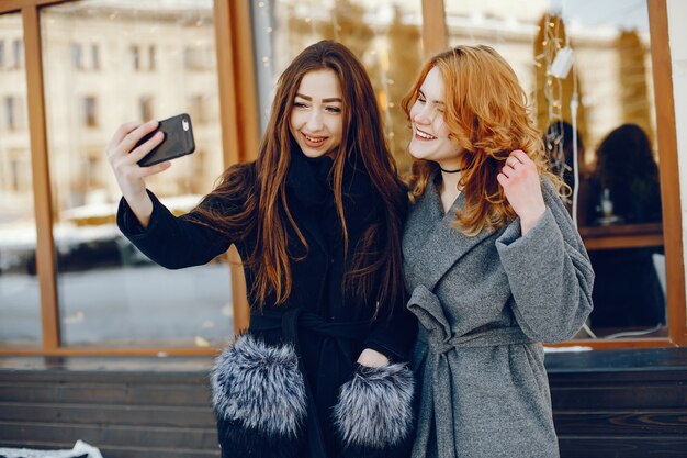 two pretty girl in a winter city