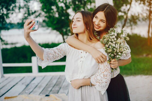 Two pretty girls in a summer park